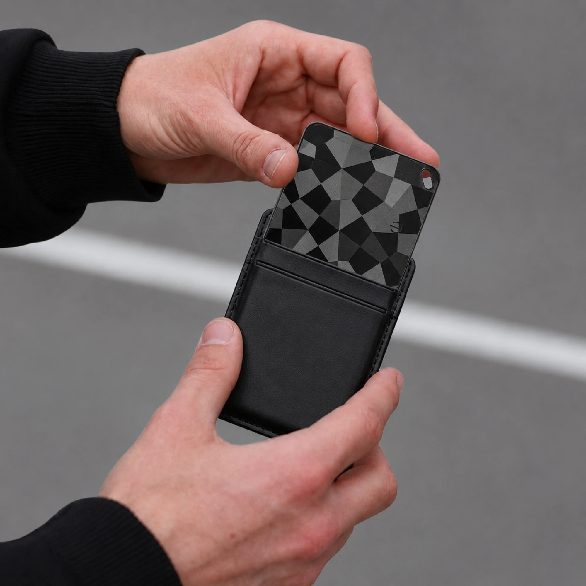 Lifestyle listing — card tracker sliding from a leather wallet